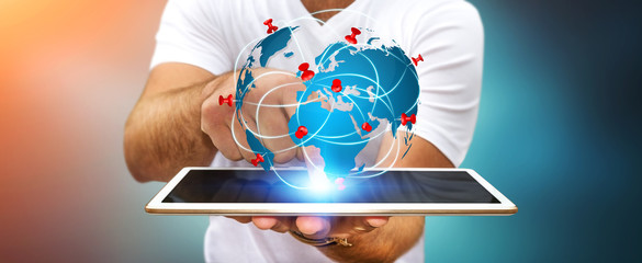 Businessman holding digital world map in his hands