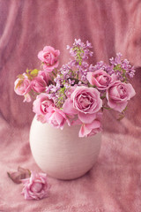 Beautiful fresh pink roses on a pink background. Vintage style ,grunge paper background. 
