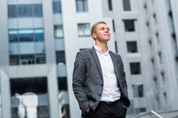 Smiling businessman portrait outdoor.background of business centers
