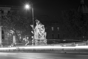 image of a bridge in Rome with winged victories travertine. Rome by night in black and white.