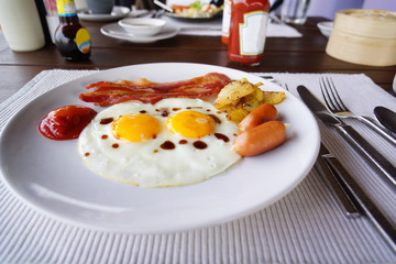 English breakfast with fried eggs, bacon, sausages,