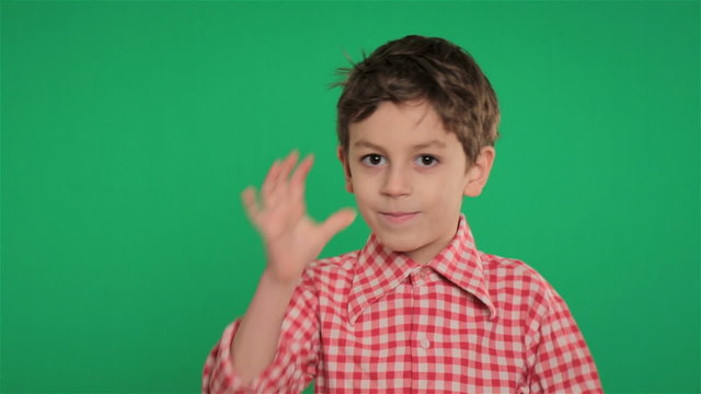 young boy making funny gesture on green screen