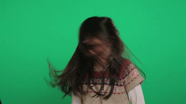 young girl shaking hair on green screen