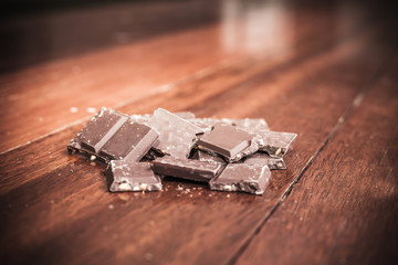 Chocolate on wood background, made vintage color tone