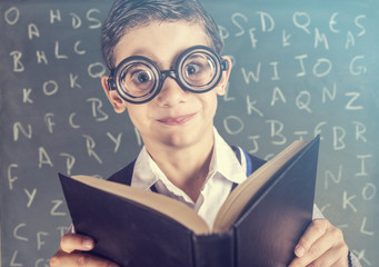 Funny nerdy school boy in classroom