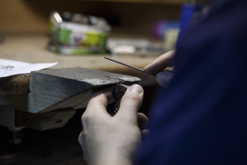 man's hands making souvenirs