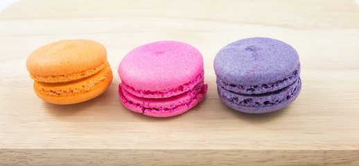Colorful macaroons variety closeup on wood background