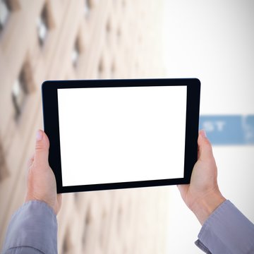 Composite image of cropped hand of man holding digital tablet