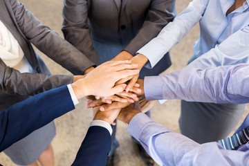 Close-up of Businesspeople stacking hands