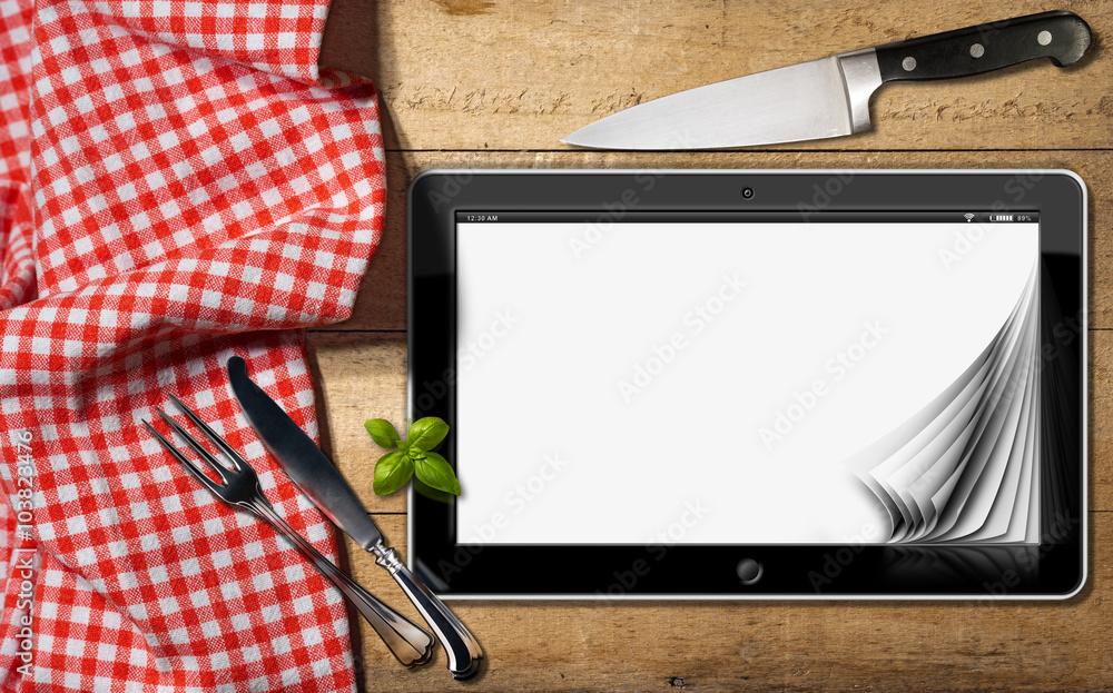 Poster tablet and cutlery on a table with tablecloth / black tablet computer with blank pages on a wooden t