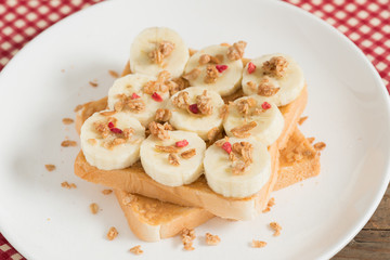 A healthy peanut butter and banana sandwich, muesli crisp with berry.