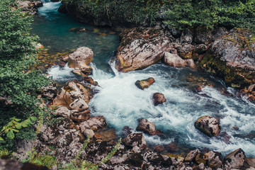 The threshold on the rocky mountain river with blue water