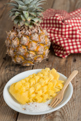 Sliced Pineapple on white plate.