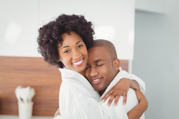 Obraz premium Happy couple hugging in the kitchen