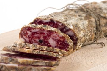 Salami sliced on cutting board, selective focus