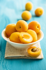 Naklejka na ściany i meble Fresh apricots in white bowl