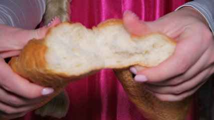 Girl tearing baguette in half