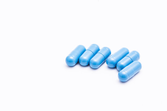 Blue pills isolated on white.