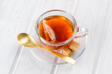 cup of tea with bag on white wood