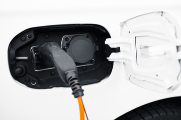 an electric car charging with power plug