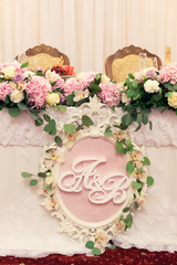 wedding table for  groom and the bride in pink flowers