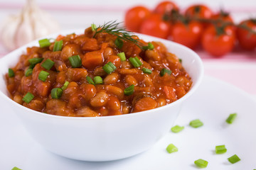 Braised beans with mushrooms, cherry and garlic clove
