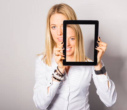 Woman holding tablet with her happy face 