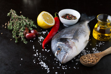 Fresh fish dorado with fragrant spices, herbs and spices