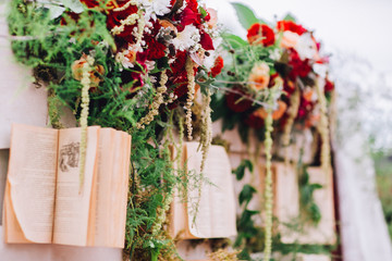 wedding ceremony arch with roses and books