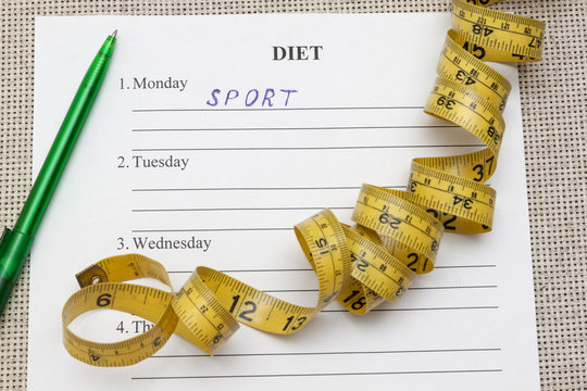paper with blank diet plan and yellow measure tape