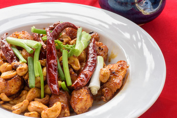 Fried cashew chicken with red background