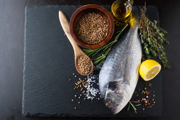 Fresh fish dorado with fragrant spices, herbs and spices
