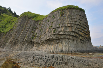 Columnar basalt jointing (geological formation). Cape Stolbchaty, Kunashir Island, Russia. - 103835493