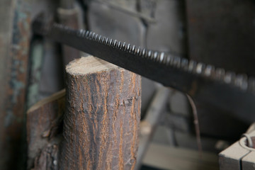 Old rusty saw on wooden background