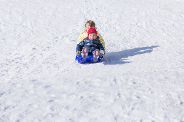 Fototapeta na wymiar Children having fun on sled