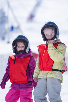 Boy and girl in helmet on ice hill