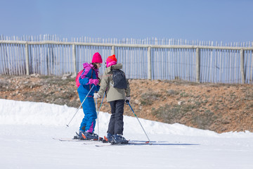 Fototapeta premium Two female skiers talking