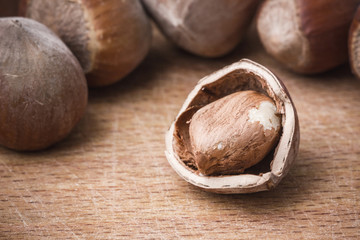 Hazelnut on wooden table background.