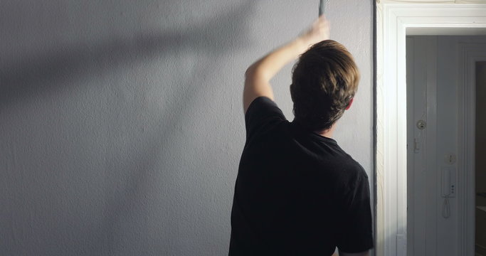 fast pace video of person painting his wall at home. New colour painted on walls in appartment.