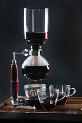 Puer tea in the siphon, shallow DOF, on black background