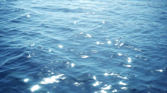 sun reflections at the water surface in slow motion