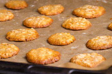 Tasty homemade oat cookies on baking tray.