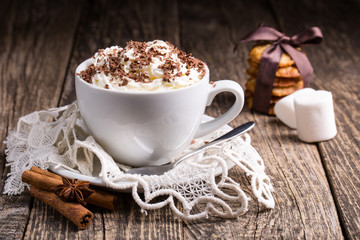 Cup of hot cappuccino with homemade oat cookies for breakfast.