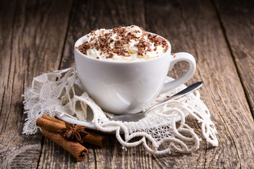 Cup of hot cappuccino with cinnamon for breakfast.