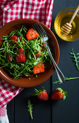 Useful strawberry salad with arugula nuts and honey