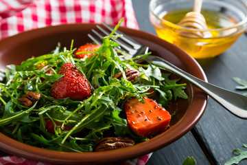Useful strawberry salad with arugula nuts and honey
