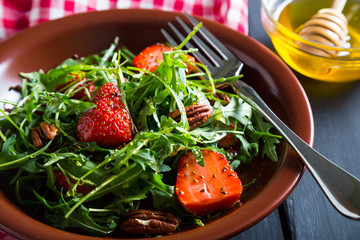 Useful strawberry salad with arugula nuts and honey