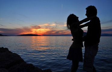 Sea sunset with silhouette of a romantic couple