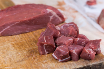 Beef steak cut into cubes. Red meat on the cutting board