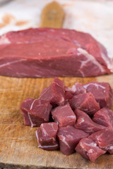 Beef steak cut into cubes. Red meat on the cutting board